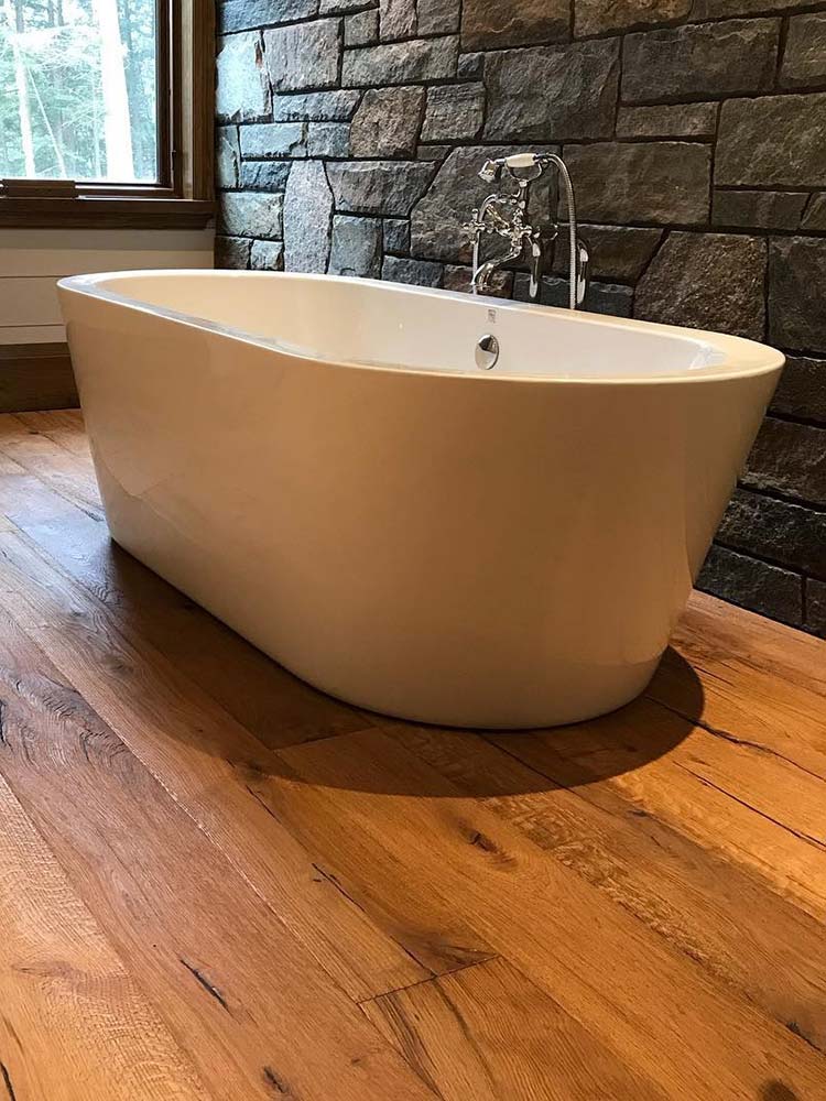 Soaker tub with warm and lustrous Meistercraft hardwood floor.