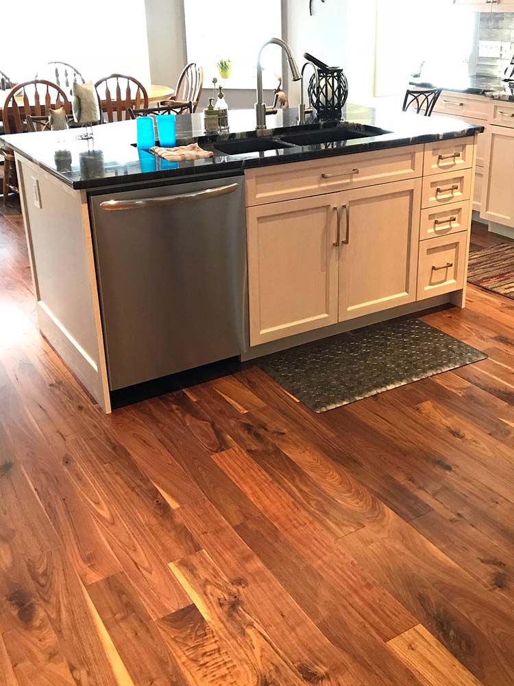 Kitchen island is set off by beautiful Meistercraft hardwood floor