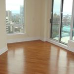 Custom hardwood flooring by Meistercraft adds natural beauty to this urban highrise apartment