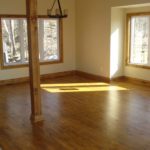 Rich golden hardwood floor by Meistercraft Wood Flooing adds beauty to this rustic cottage