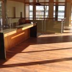 Rich and lustrous custom hardwood floor by Meistercraft Wood Flooring anchors this open concept kitchen