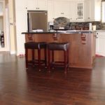 Rich hardwood adds beauty to this open concept kitchen; custom hardwood floor by Meistercraft Wood Flooring