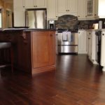 Rich hardwood adds beauty to this open concept kitchen; custom hardwood floor by Meistercraft Wood Flooring