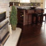 Elegance of dark hardwood in this open concept kitchen / livingroom; flooring by Meistercraft Wood Flooring