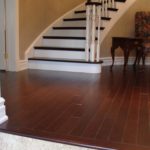 Entrance and curved stairs in custom hardwood by Meistercraft Wood Flooring