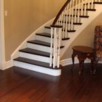 Entrance and curved stairs in custom hardwood by Meistercraft Wood Flooring