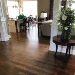 Dark hardwood flooring flows beautifully into an open-concept kitchen; custom flooring by Meistercraft Wood Flooring