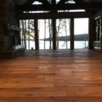 Rich solid wood flooring sets the tone in this bright, timberframe greatroom; custom flooring by Meistercraft Wood Flooring