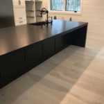 Light coloured hardwood brightens this open concept kitchen; custom hardwood floor by Meistercraft Wood Flooring